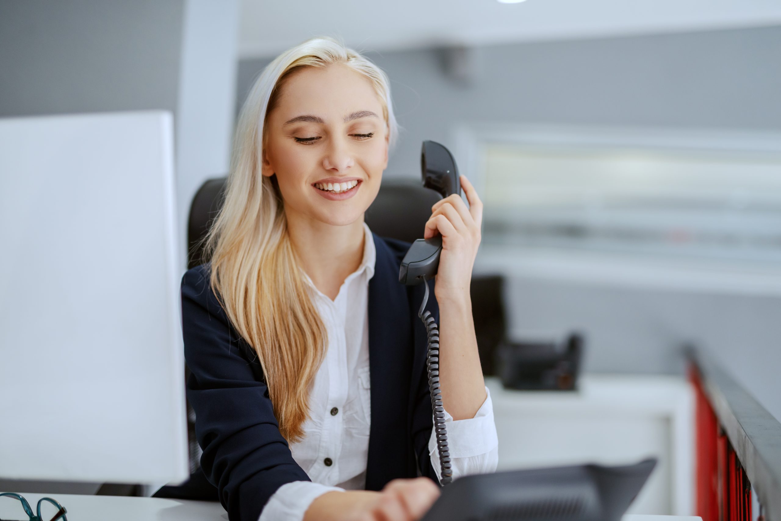 Smiling beautiful Caucasian businesswoman having phone call while sitting in office. Life is change. Growth is optional. Choose wisely. Smiling beautiful Caucasian businesswoman having phone call while sitting in office. Life is change. Growth is optional. Choose wisely.